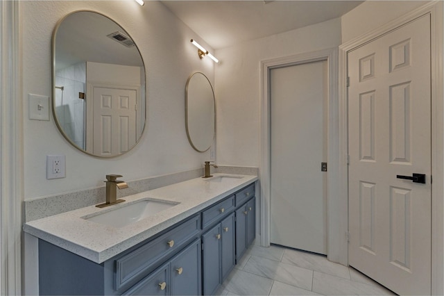 bathroom featuring visible vents, a sink, and double vanity