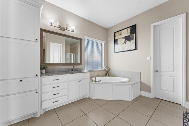 bathroom featuring baseboards, tile patterned flooring, vanity, a shower stall, and a bath