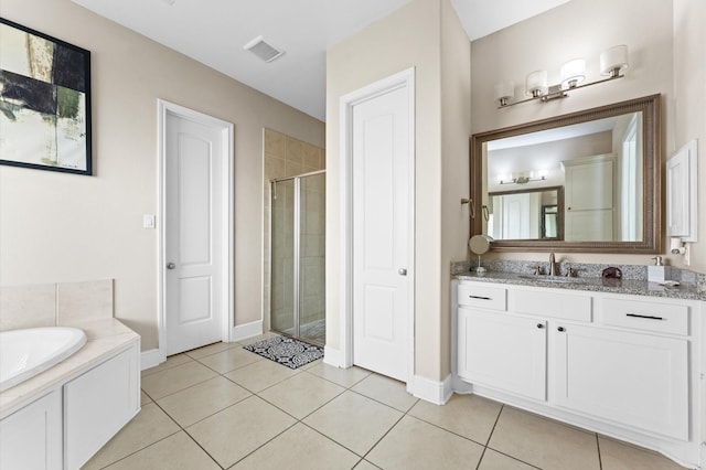 full bathroom featuring visible vents, baseboards, vanity, tile patterned floors, and a stall shower