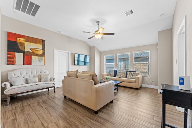 living room with lofted ceiling, ceiling fan, visible vents, and wood finished floors