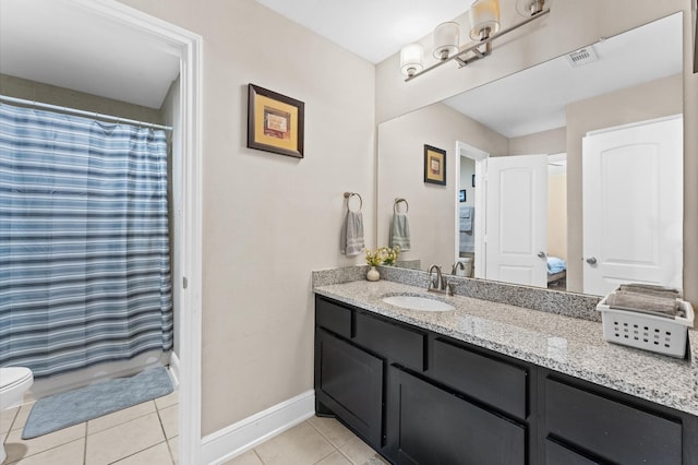 bathroom featuring visible vents, baseboards, toilet, tile patterned flooring, and vanity