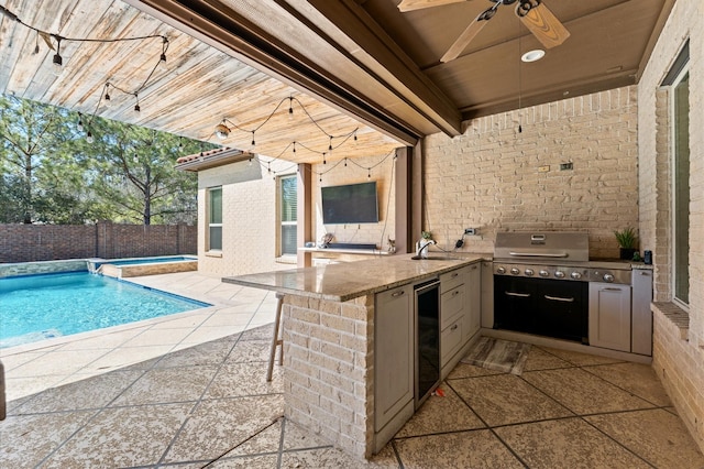 view of patio / terrace with ceiling fan, a fenced backyard, outdoor wet bar, area for grilling, and a fenced in pool