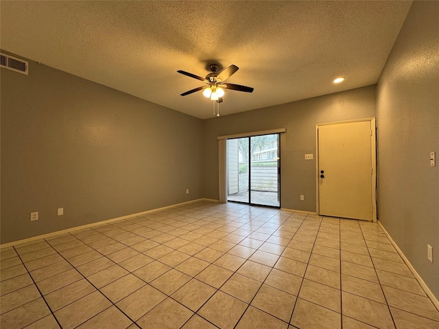 unfurnished room with light tile patterned floors, visible vents, a ceiling fan, a textured ceiling, and baseboards