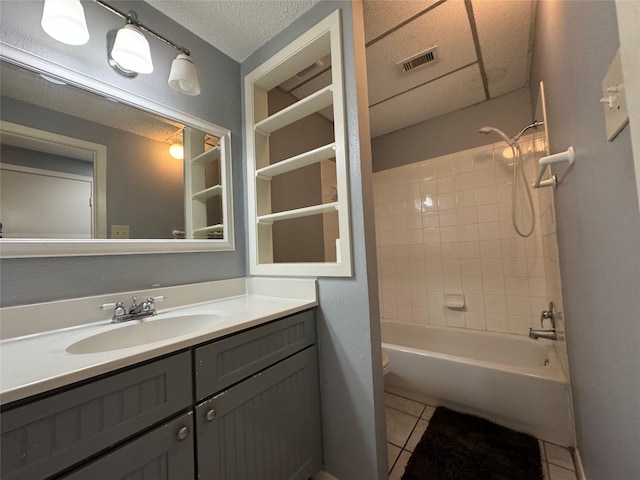 bathroom with a textured ceiling, toilet, bathing tub / shower combination, visible vents, and tile patterned floors