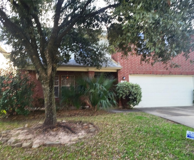 view of front facade with a garage, concrete driveway, and brick siding