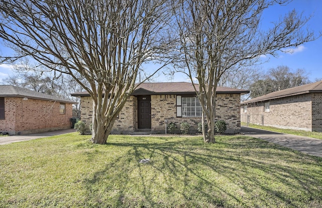 single story home with brick siding and a front yard