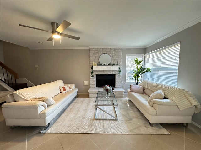 living room featuring a stone fireplace, light tile patterned flooring, and crown molding