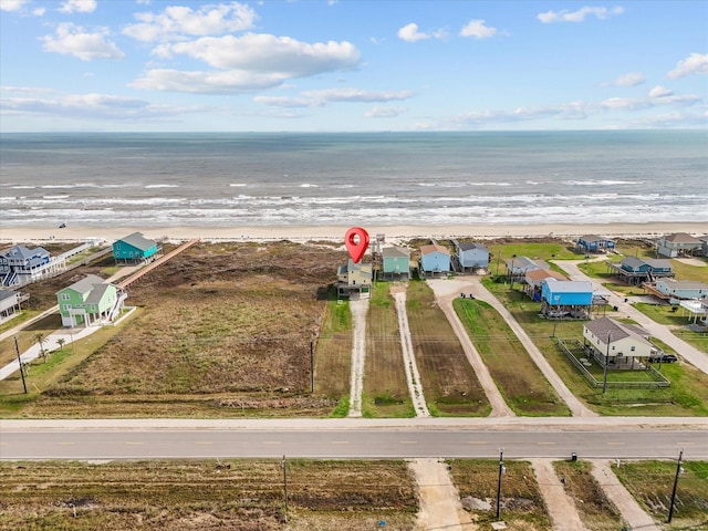 drone / aerial view with a water view and a view of the beach