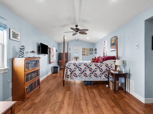 bedroom with visible vents, vaulted ceiling, multiple windows, and wood finished floors