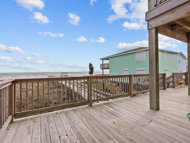 deck featuring a water view and a beach view