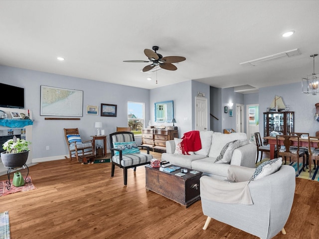 living room with light wood-type flooring, ceiling fan, baseboards, and recessed lighting