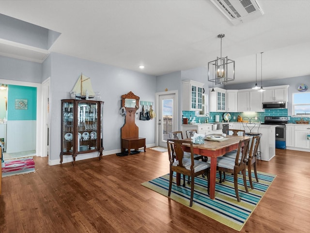 dining room featuring dark wood-style floors, baseboards, and visible vents