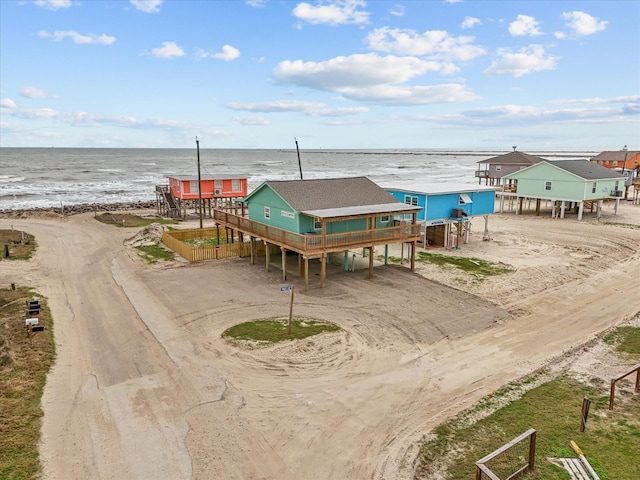 drone / aerial view featuring a water view and a beach view