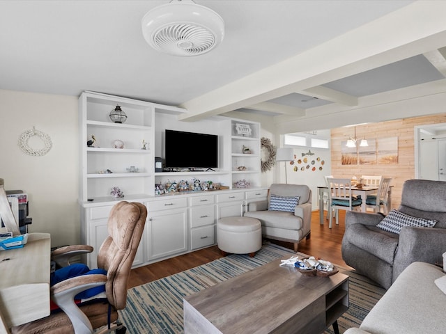 living room with wooden walls, beam ceiling, wood finished floors, and visible vents