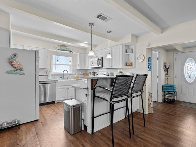 kitchen featuring plenty of natural light, beamed ceiling, stainless steel appliances, white cabinetry, and open shelves