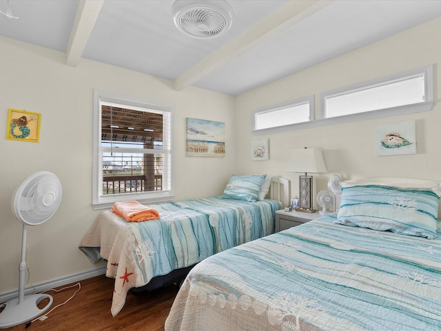 bedroom with beam ceiling, multiple windows, and visible vents