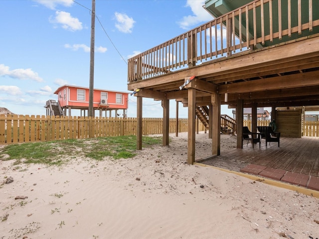 view of patio / terrace featuring stairs, a wooden deck, and fence