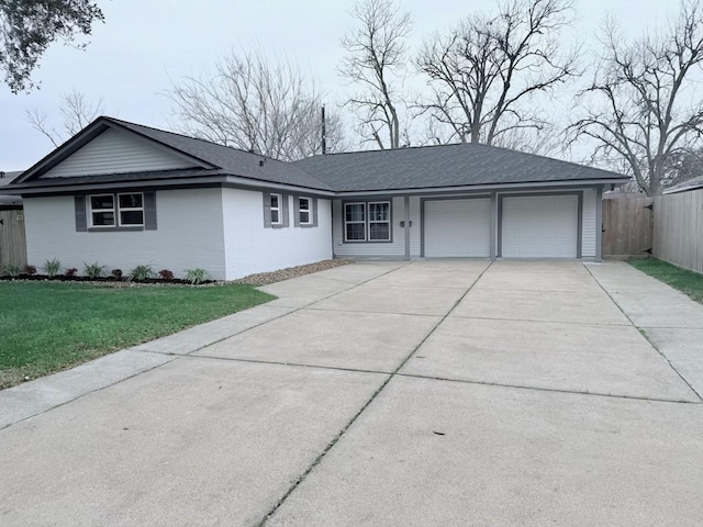 single story home with concrete driveway, an attached garage, fence, a front lawn, and brick siding