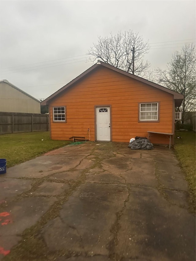 exterior space with fence and a lawn