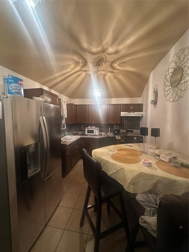 dining space featuring light tile patterned floors