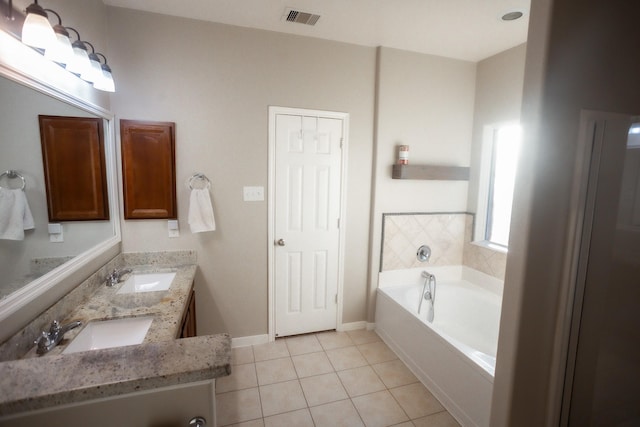 full bath featuring visible vents, a sink, a bath, and tile patterned floors