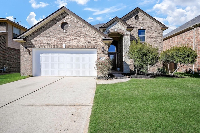 view of front of property with a garage, a front yard, concrete driveway, and brick siding