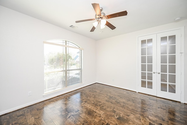 empty room with ceiling fan, visible vents, baseboards, french doors, and dark wood-style floors