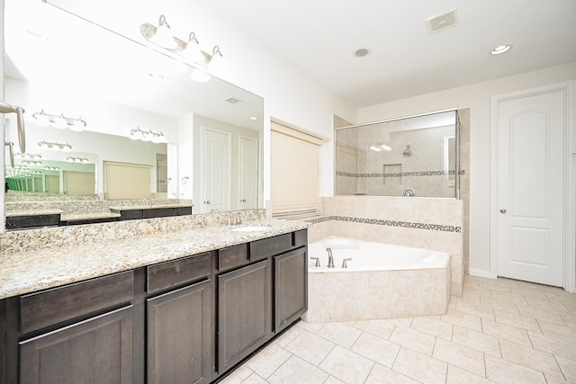 bathroom with visible vents, tile patterned floors, a garden tub, vanity, and a walk in shower