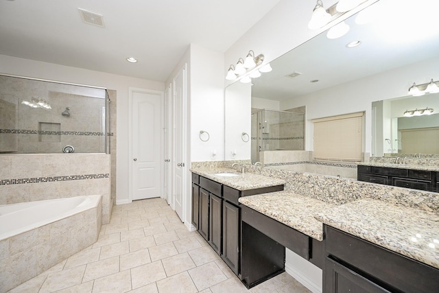 bathroom with a stall shower, visible vents, tile patterned floors, a garden tub, and vanity