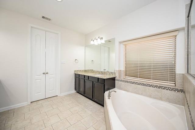 full bathroom featuring a closet, visible vents, vanity, baseboards, and a bath