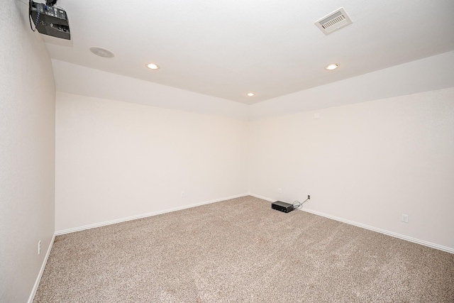 carpeted empty room with recessed lighting, visible vents, and baseboards