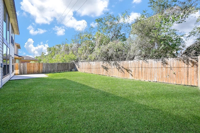 view of yard with a fenced backyard