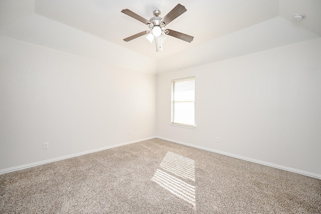 unfurnished room featuring ceiling fan, carpet floors, lofted ceiling, and baseboards