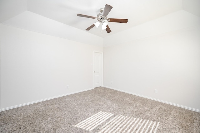 carpeted empty room with a ceiling fan, lofted ceiling, and baseboards