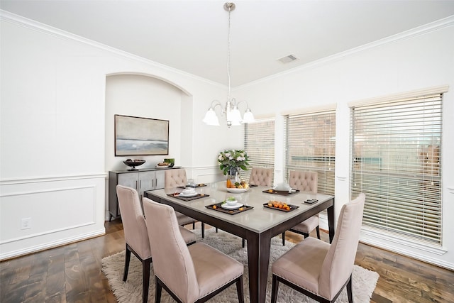 dining area featuring dark wood-style floors, visible vents, and ornamental molding