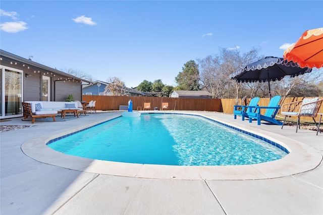 view of pool with a fenced in pool, a fenced backyard, and a patio