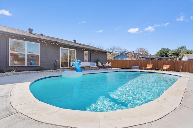 view of swimming pool with fence, a fenced in pool, and a patio