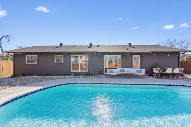 view of swimming pool featuring fence, outdoor lounge area, and a fenced in pool