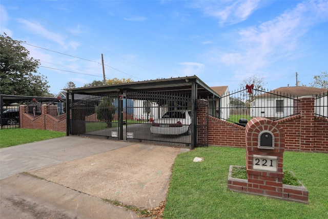 exterior space featuring a fenced front yard, a gate, driveway, and a carport