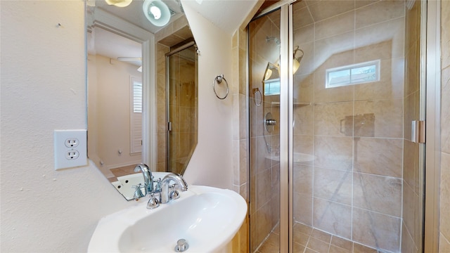 full bath featuring a sink and a shower stall