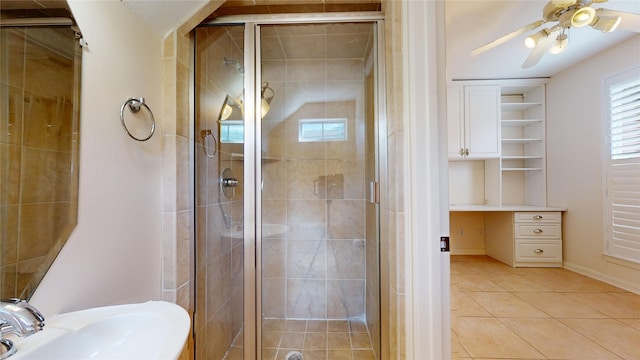 bathroom featuring a sink, a stall shower, ceiling fan, and tile patterned flooring