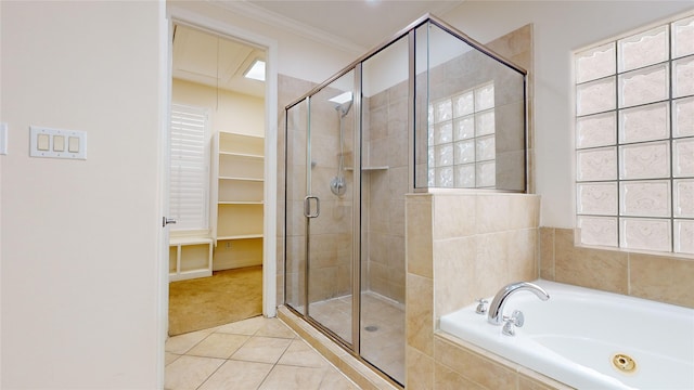 bathroom with tile patterned floors, a spacious closet, ornamental molding, plenty of natural light, and a bath