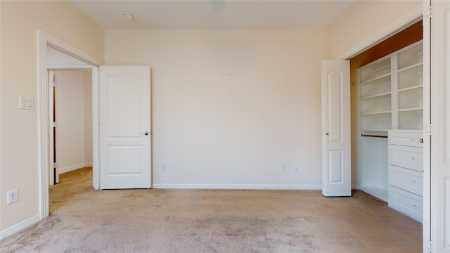 unfurnished bedroom with baseboards and light colored carpet