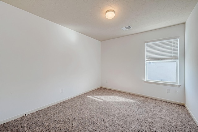 unfurnished room featuring carpet floors, a textured ceiling, and baseboards