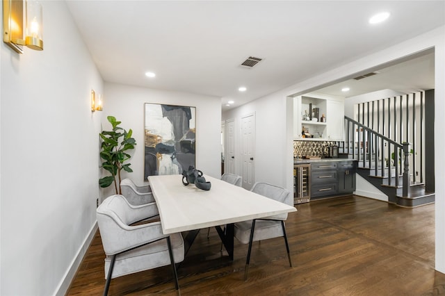 516 W 30th St, Houston, TX 77018 - dining space featuring beverage cooler, a bar, dark wood-style floors, recessed lighting, and baseboards