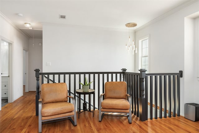 516 W 30th St, Houston, TX 77018 - living area with attic access, crown molding, wood finished floors, an upstairs landing, and a chandelier
