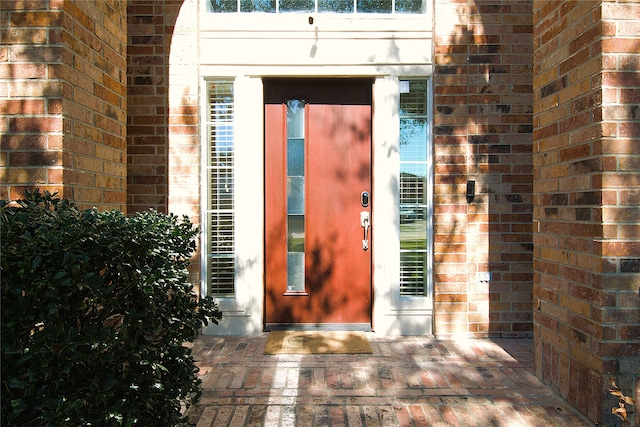 property entrance with brick siding