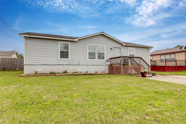 view of front of home featuring a front yard, crawl space, and fence