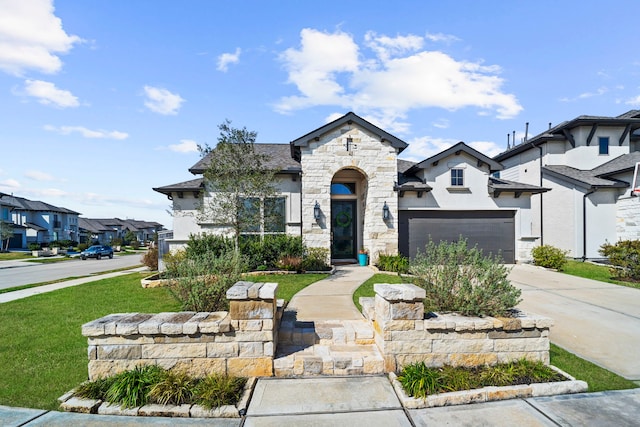 view of front of property with driveway, stone siding, a residential view, an attached garage, and stucco siding