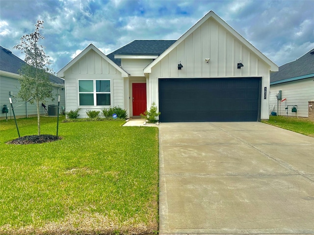 view of front of house with a garage, central AC, concrete driveway, board and batten siding, and a front yard